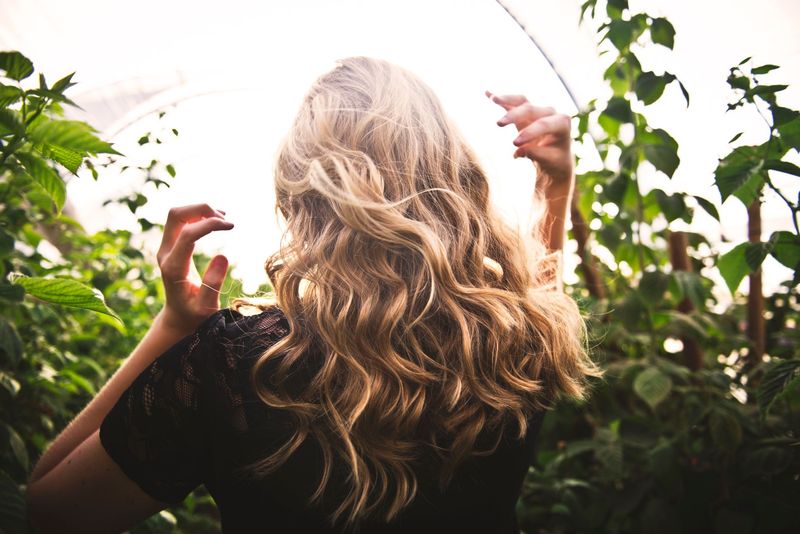 Stylist customizing a wig with professional salon tools